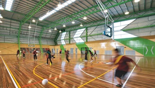 The sports hall contains a large flexible court for basketball and volleyball, a smaller specially lit hall for badminton and table tennis, plus sports science, reception, storage and amenity areas